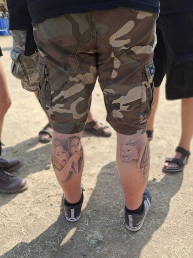 Man with the "Woman yelling at a cat" meme tattooed on both of his calves.