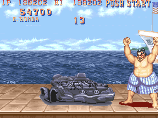 Street Fighter 2. E-Honda stands beside a smashed up car from the first bonus level.